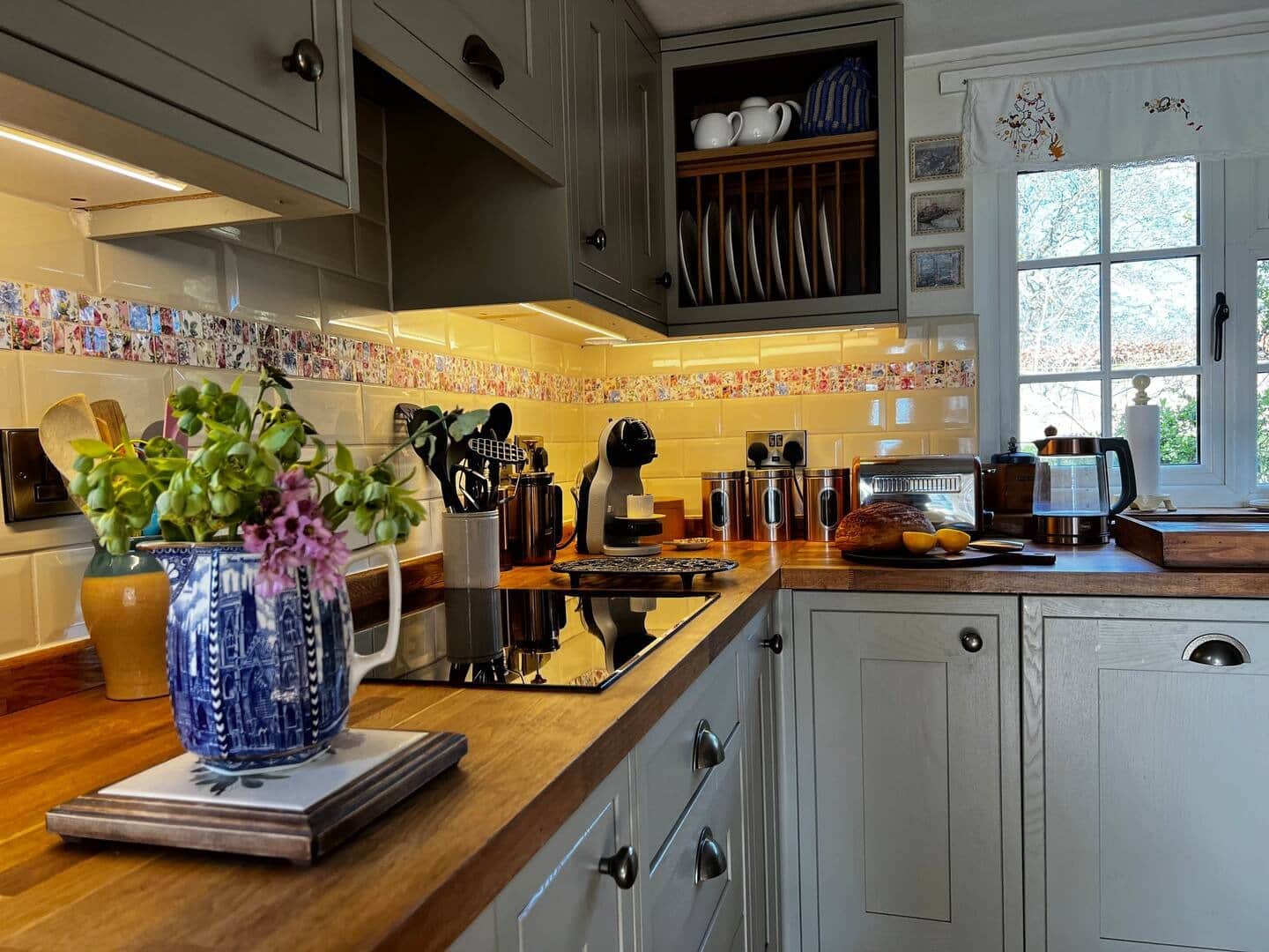 Shaker-style kitchen with fully integrated appliances, and all the utensils you would need to cook a meal  